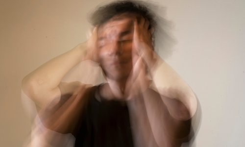 Blurred image of a man with a contemplative expression, symbolizing the confusion and overwhelming emotions associated with ADHD and emotions