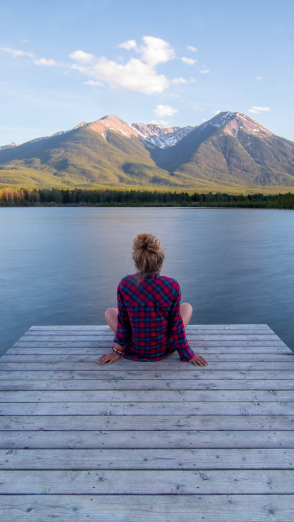 Woman sitting peacefully in nature in North Carolina, reflecting on self-improvement through EMDR therapy for ADHD